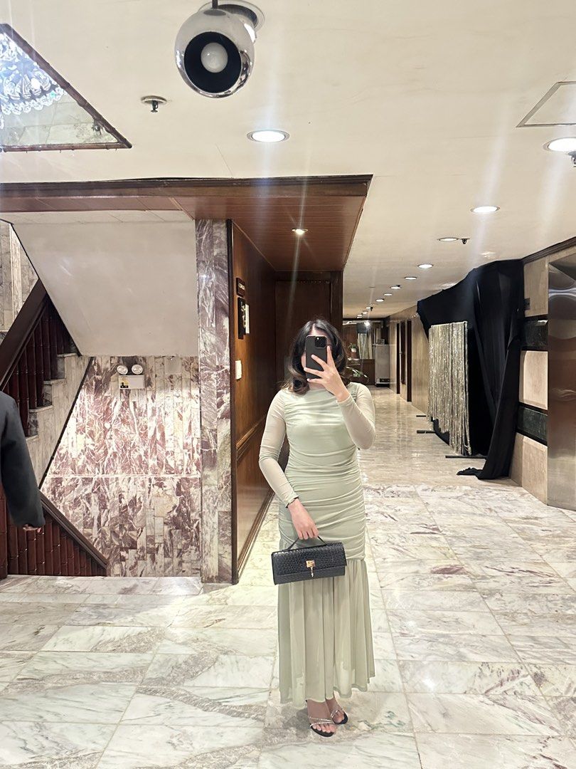 Sage Green Ruched Maxi Dress (Category: Dresses) located in Pasig City. Submitted by summers2022 (Listing ID 1436567629, Image 3). Description: Measurements (in inches) Bust: 31.8 Waist: 28.7 Hip: 35.2 Length: 53.5 Used only once for a wedding - Sage green maxi dress - Ruched bodice - Long sleeves - Flowing skirt - Ideal for special occasions - Light green color - Fitted silhouette - Flattering design .