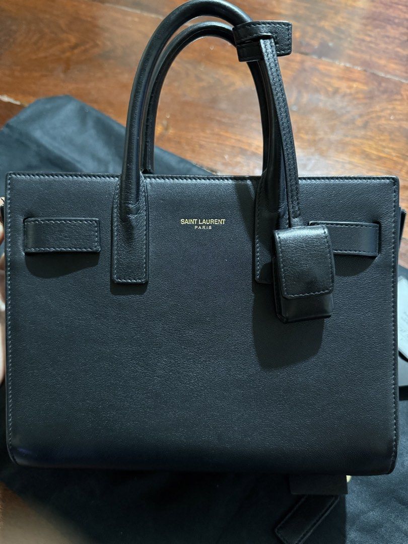 Saint Laurent Sac de Jour Small Black (Category: Luxury Bags & Wallets) located in Calamba. Submitted by eskaparatengpuno (Listing ID 1436557311, Image 2). Description: - Authentic Saint Laurent Sac de Jour Small handbag - Color: Black - Features: - Structured silhouette - Top handles - Padlock with keys - Includes: Dust bag and authenticity card Bag strap included as it is already lost .