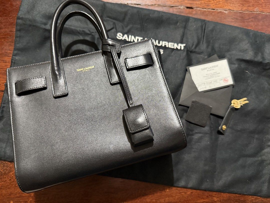 Saint Laurent Sac de Jour Small Black (Category: Luxury Bags & Wallets) located in Calamba. Submitted by eskaparatengpuno (Listing ID 1436557311, Image 1). Description: - Authentic Saint Laurent Sac de Jour Small handbag - Color: Black - Features: - Structured silhouette - Top handles - Padlock with keys - Includes: Dust bag and authenticity card Bag strap included as it is already lost .