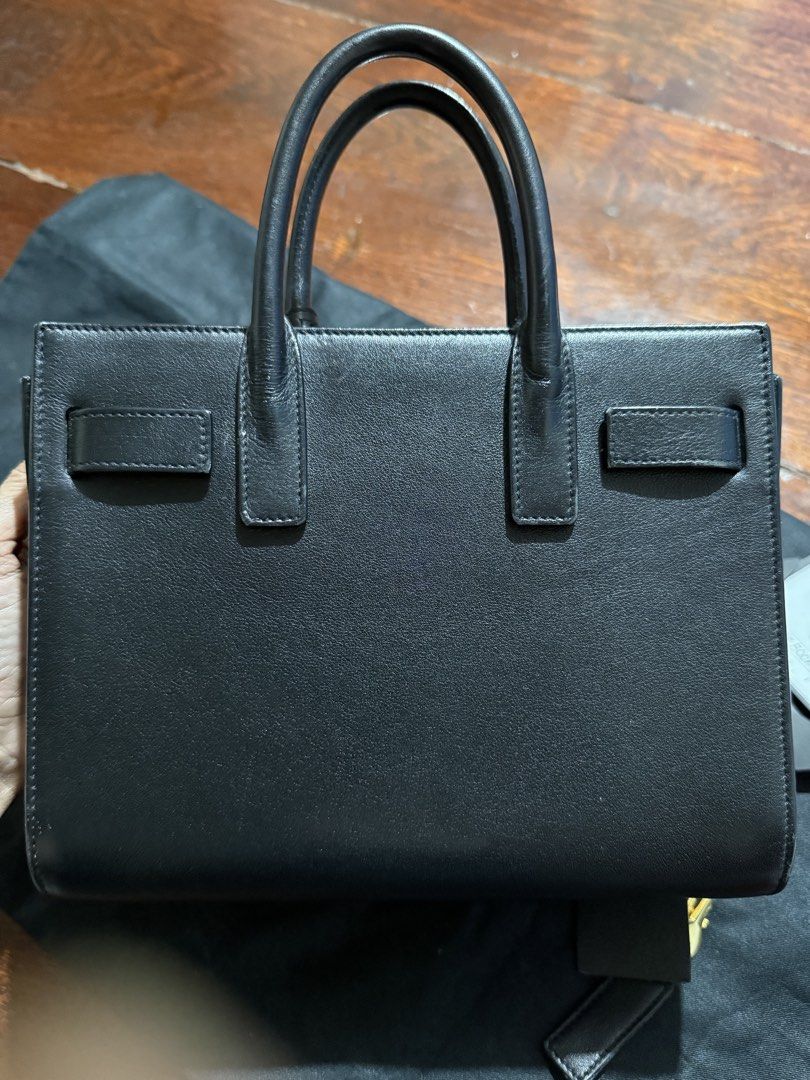 Saint Laurent Sac de Jour Small Black (Category: Luxury Bags & Wallets) located in Calamba. Submitted by eskaparatengpuno (Listing ID 1436557311, Image 3). Description: - Authentic Saint Laurent Sac de Jour Small handbag - Color: Black - Features: - Structured silhouette - Top handles - Padlock with keys - Includes: Dust bag and authenticity card Bag strap included as it is already lost .