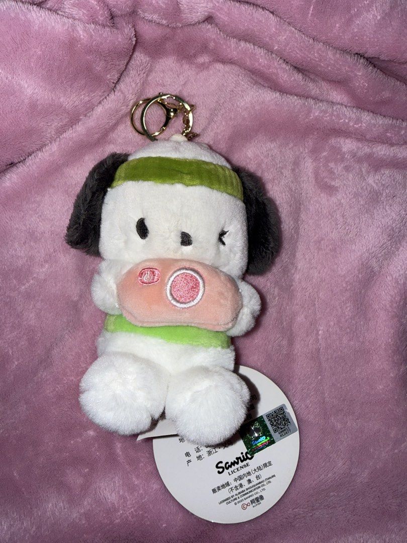 Sanrio Pochacco Plush Keychain (Category: Plushies & Soft Toys) located in Bulacan. Submitted by xxmeiji (Listing ID 1436561433, Image 1). Description: - Adorable Sanrio Pochacco plush keychain. - Features Pochacco wearing a green headband and a pink and green outfit. - Includes a keychain ring for easy attachment. - Comes with the original tag. - Perfect for Sanrio fans and collectors..