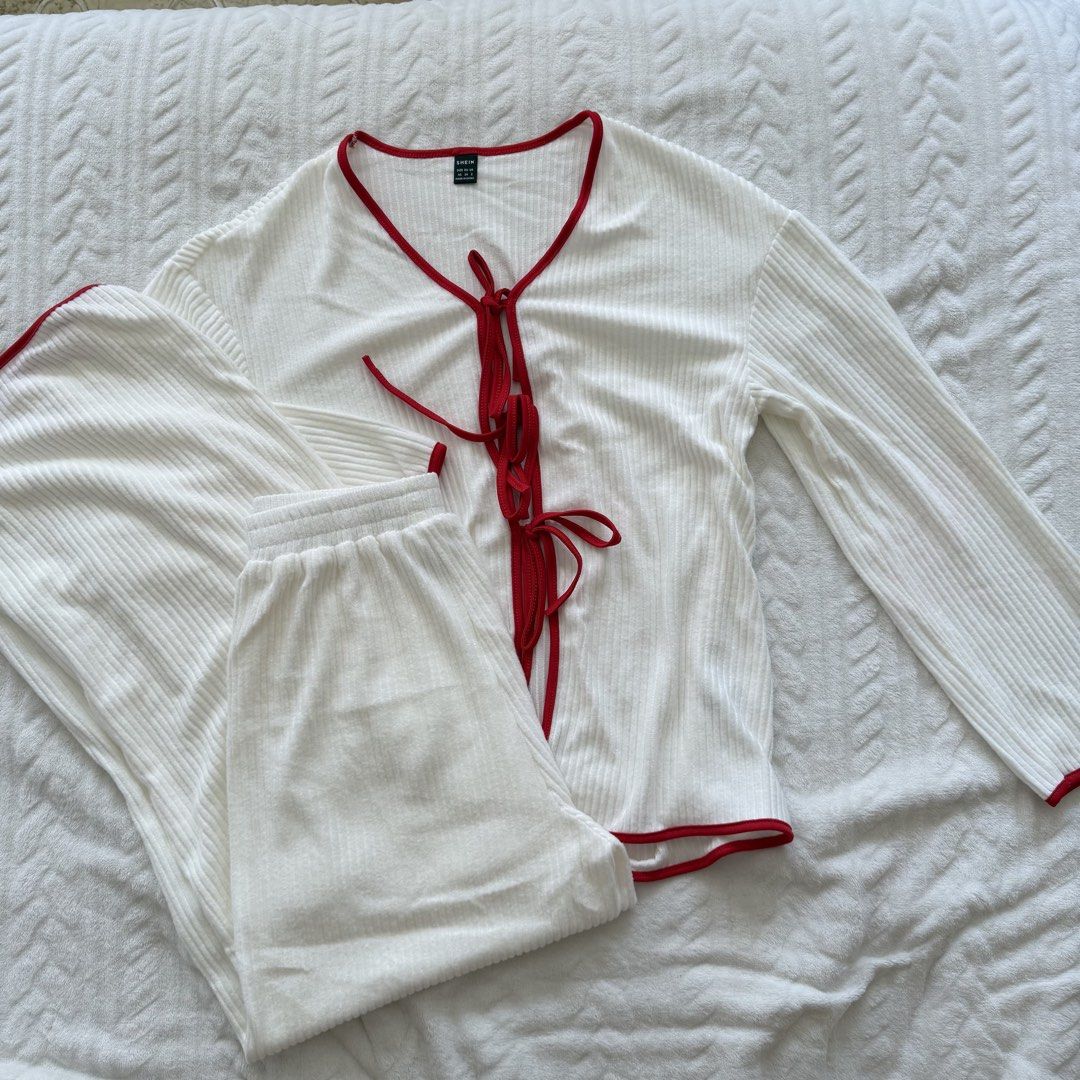 Shein White Ribbed Pajama Set (Category: Undergarments & Loungewear) located in Pasig City. Submitted by sichi.ph (Listing ID 1436476075, Image 2). Description: - White ribbed pajama set - Red trim detailing - Top: Tie-up front, long sleeves - Pants: Elastic waistband - Soft, comfortable fabric - Perfect for sleep or lounging.