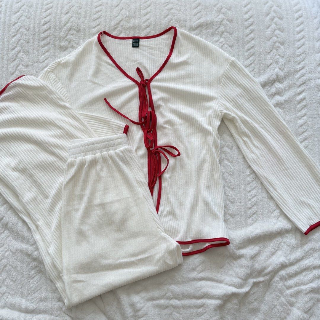 Shein White Ribbed Pajama Set (Category: Undergarments & Loungewear) located in Pasig City. Submitted by sichi.ph (Listing ID 1436476075, Image 3). Description: - White ribbed pajama set - Red trim detailing - Top: Tie-up front, long sleeves - Pants: Elastic waistband - Soft, comfortable fabric - Perfect for sleep or lounging.