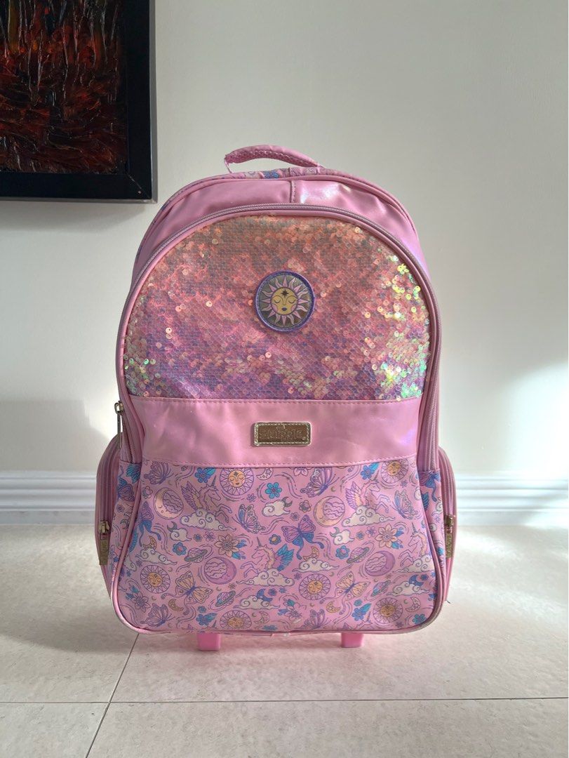 Smiggle cosmic light up trolley (Category: Babies & Kids Fashion) located in Carmona. Submitted by sclosetcleanup (Listing ID 1436649416, Image 1). Description: - Rolling stroller backpack with light up wheels - Whimsical butterfly, moon, and sun pattern - Sparkling sequined front panel - Convenient handle and wheels - Side pockets for extra storage - Adjustable shoulder straps - Original, bought for 4K+ - Can include a free matching lunch bag.