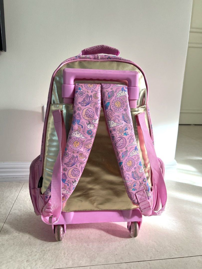 Smiggle cosmic light up trolley (Category: Babies & Kids Fashion) located in Carmona. Submitted by sclosetcleanup (Listing ID 1436649416, Image 2). Description: - Rolling stroller backpack with light up wheels - Whimsical butterfly, moon, and sun pattern - Sparkling sequined front panel - Convenient handle and wheels - Side pockets for extra storage - Adjustable shoulder straps - Original, bought for 4K+ - Can include a free matching lunch bag.