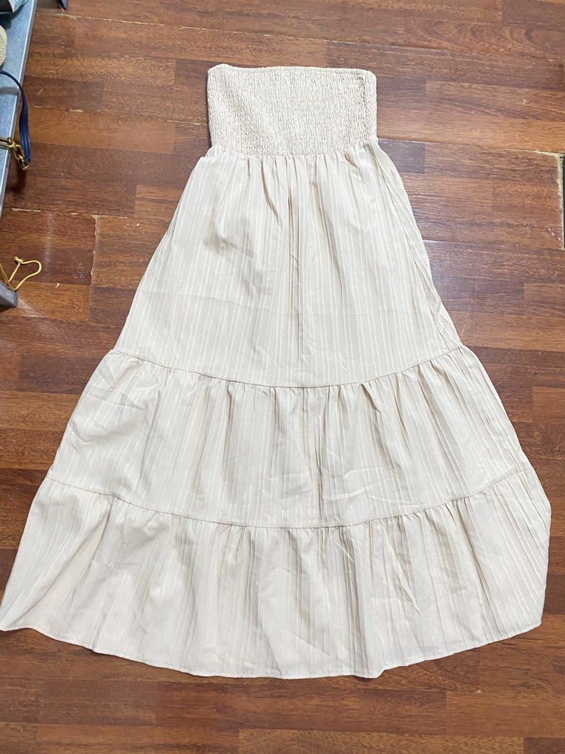 Strapless Tiered Dress (Category: Dresses) located in Cavite. Submitted by prelovedclothesofzoe (Listing ID 1436554123, Image 1). Description: - Strapless midi dress - Smocked bodice - Tiered skirt - Neutral color with vertical stripes - Lightweight fabric - Ideal for casual or summer wear.