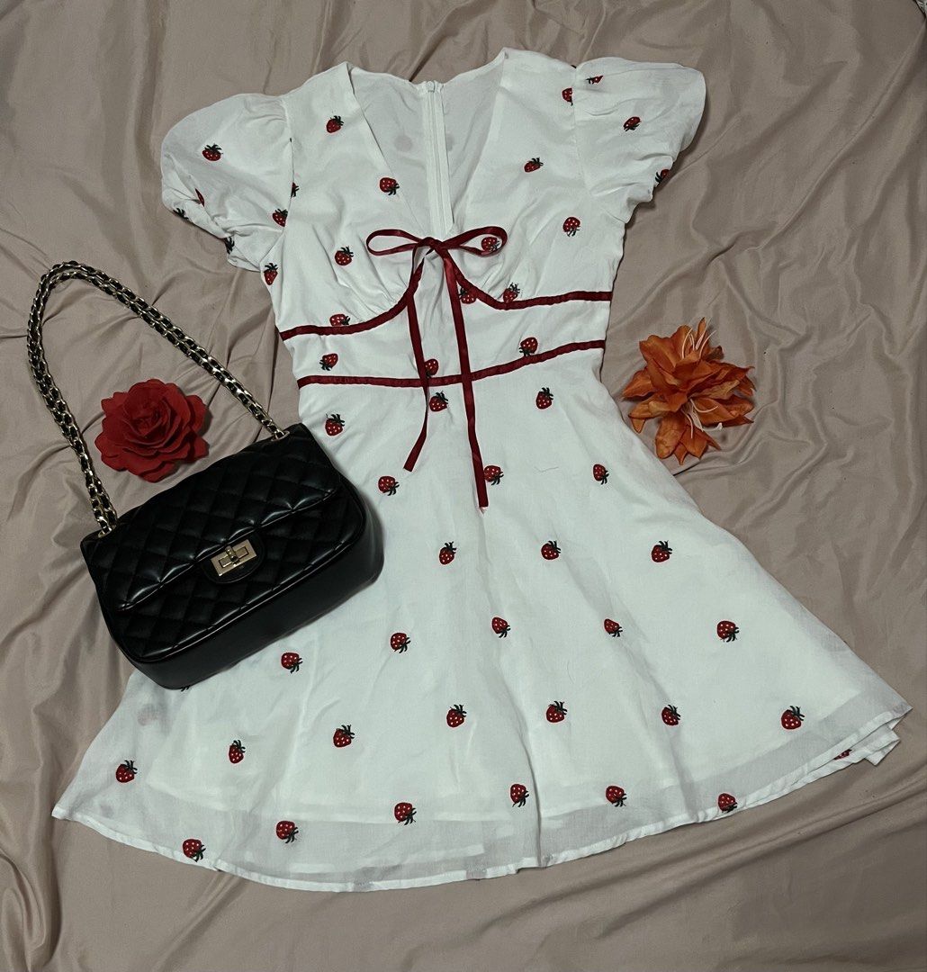 Strawberry Embroidered Dress (Category: Dresses) located in Manila. Submitted by declutterwithandi.148 (Listing ID 1436525144, Image 1). Description: - White dress with adorable strawberry embroidery - Flattering V-neckline - Cute short puff sleeves - Fitted waist for a great silhouette - Charming red ribbon detail at bust and waist - Flowing, flared skirt - Perfect for warm weather with its lightweight fabric.