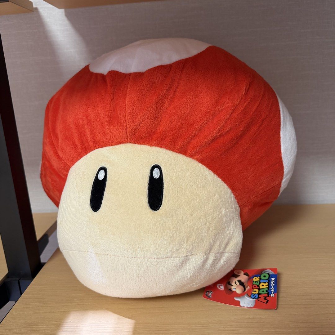 Super Mario Bros. Giant Mushroom Plush (Category: Plushies & Soft Toys) located in Manila. Submitted by toysunlimited (Listing ID 1436549253, Image 1). Description: - Super Mario Bros. Giant Mushroom plush toy. - Features the iconic red cap with white spots. - Cream-colored face and black eyes. - Includes the original tag. - Perfect collectible for Super Mario fans!.