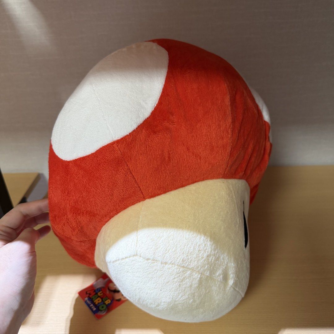 Super Mario Bros. Giant Mushroom Plush (Category: Plushies & Soft Toys) located in Manila. Submitted by toysunlimited (Listing ID 1436549253, Image 2). Description: - Super Mario Bros. Giant Mushroom plush toy. - Features the iconic red cap with white spots. - Cream-colored face and black eyes. - Includes the original tag. - Perfect collectible for Super Mario fans!.
