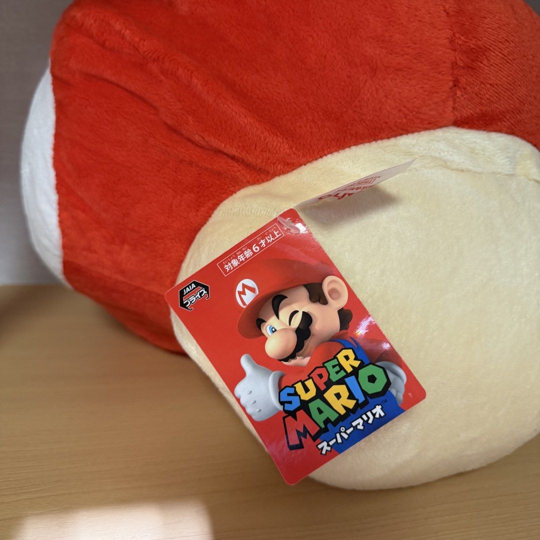Super Mario Bros. Giant Mushroom Plush (Category: Plushies & Soft Toys) located in Manila. Submitted by toysunlimited (Listing ID 1436549253, Image 3). Description: - Super Mario Bros. Giant Mushroom plush toy. - Features the iconic red cap with white spots. - Cream-colored face and black eyes. - Includes the original tag. - Perfect collectible for Super Mario fans!.
