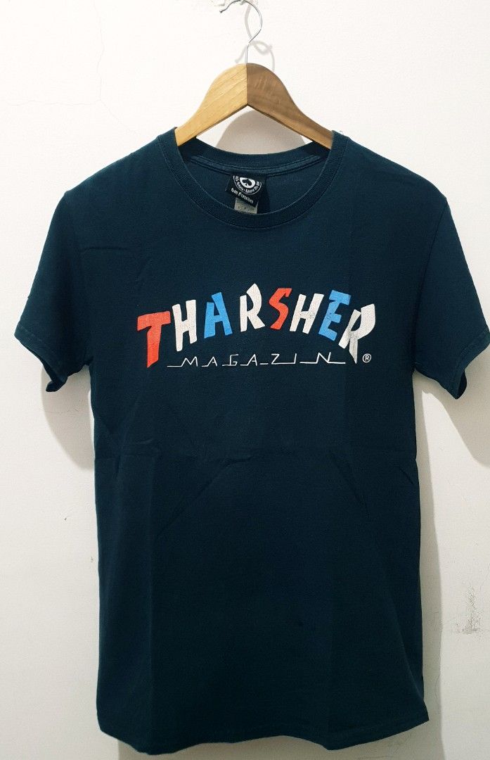 Thrasher Magazine T-shirt (Category: Tshirts & Polo Shirts ) located in Taguig. Submitted by thriftedminds (Listing ID 1436627777, Image 1). Description: - Thrasher Magazine T-shirt - Dark blue color - Features the iconic Thrasher logo in red, white, and blue - Crew neck and short sleeves - Tag indicates it's from San Francisco.