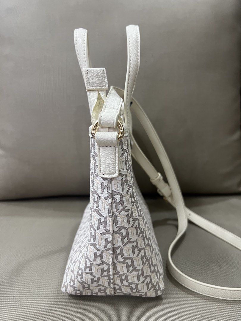 Tommy Hilfiger Monogram Crossbody Bag (Category: Cross-body Bags) located in Quezon City. Submitted by janellemariano (Listing ID 1436568864, Image 2). Description: - Tommy Hilfiger sling bag - White and gray monogram pattern - Top handle and detachable sling strap - Interior small pocket - Zipper closure - Gold-tone hardware - Includes original tag.