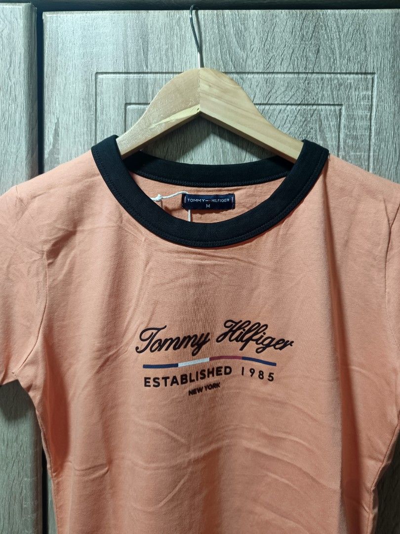 Tommy Hilfiger Peach Ringer T-shirt Medium (Category: Shirts) located in Manila. Submitted by iasoluxe (Listing ID 1436598988, Image 3). Description: Tommy Hilfiger Peach Ringer Women's T-shirt 🎨 Color: Peach 🔖 Size: Medium Dimes: Width: 17.5 in Length: 24.5 in Features: - Cotton fabric - 3D logo graphic - Ringer tee - Fit for the summer Mop: Gcash 📍Location: Manila Courier: Lalamove 🛵: for same time delivery within Manila Jnt 📦: for nationw
