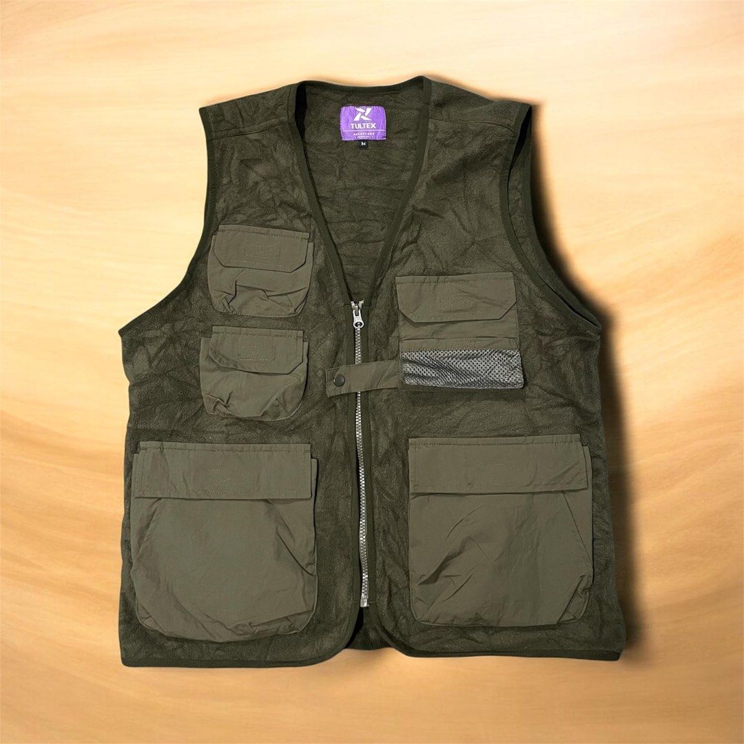 Tultex Adventure Survive Vest - Olive Green - Medium (Category: Vests) located in Cabuyao City. Submitted by bulandos (Listing ID 1436627752, Image 1). Description: - Tultex Adventure Survive vest - Olive green color - Size: Medium - Features: - Multiple pockets - Zip-up front - Mesh pocket detail - Soft, fleece-like interior - Made in Myanmar - Designed for outdoor activities.