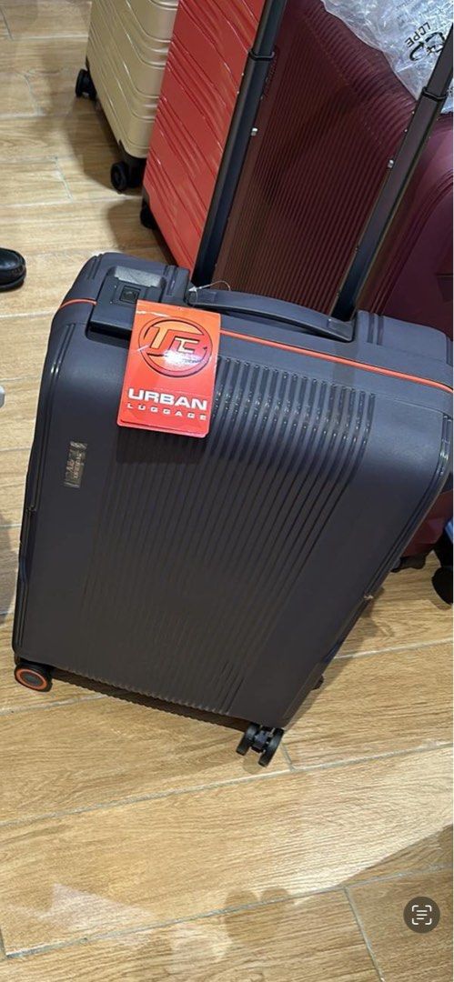 Urban Luggage Suitcase (Category: Luggage) located in Bulacan. Submitted by gleeanneorbito (Listing ID 1436543658, Image 1). Description: - Urban Luggage suitcase - Stylish dark grey design with orange accents - Retractable handle for easy maneuvering - Smooth-rolling wheels - Durable, textured surface with vertical lines - Medium size, perfect for various trips - Includes original Urban Luggage tag.