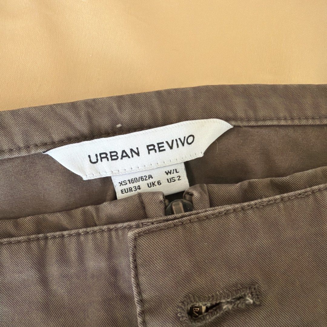 Urban Revivo Mini Skirt (Category: Skirts) located in Taguig. Submitted by charmedandcollected (Listing ID 1436534564, Image 2). Description: - Urban Revivo mini skirt - Neutral color - Size: XS (EUR 34, UK 6) - Classic design - Button and zipper closure - Features belt loops - Simple, clean look - Ideal for casual outfits.
