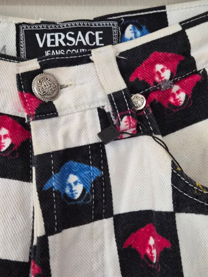 Versace Jeans Couture Checkered Jeans (Category: Jeans) located in Makati City. Submitted by shaundeshop (Listing ID 1436564022, Image 2). Description: - Versace Jeans Couture jeans - Black and white checkered pattern - Colorful Medusa head prints - Versace logo button closure - Classic five-pocket design - Waist: 26".