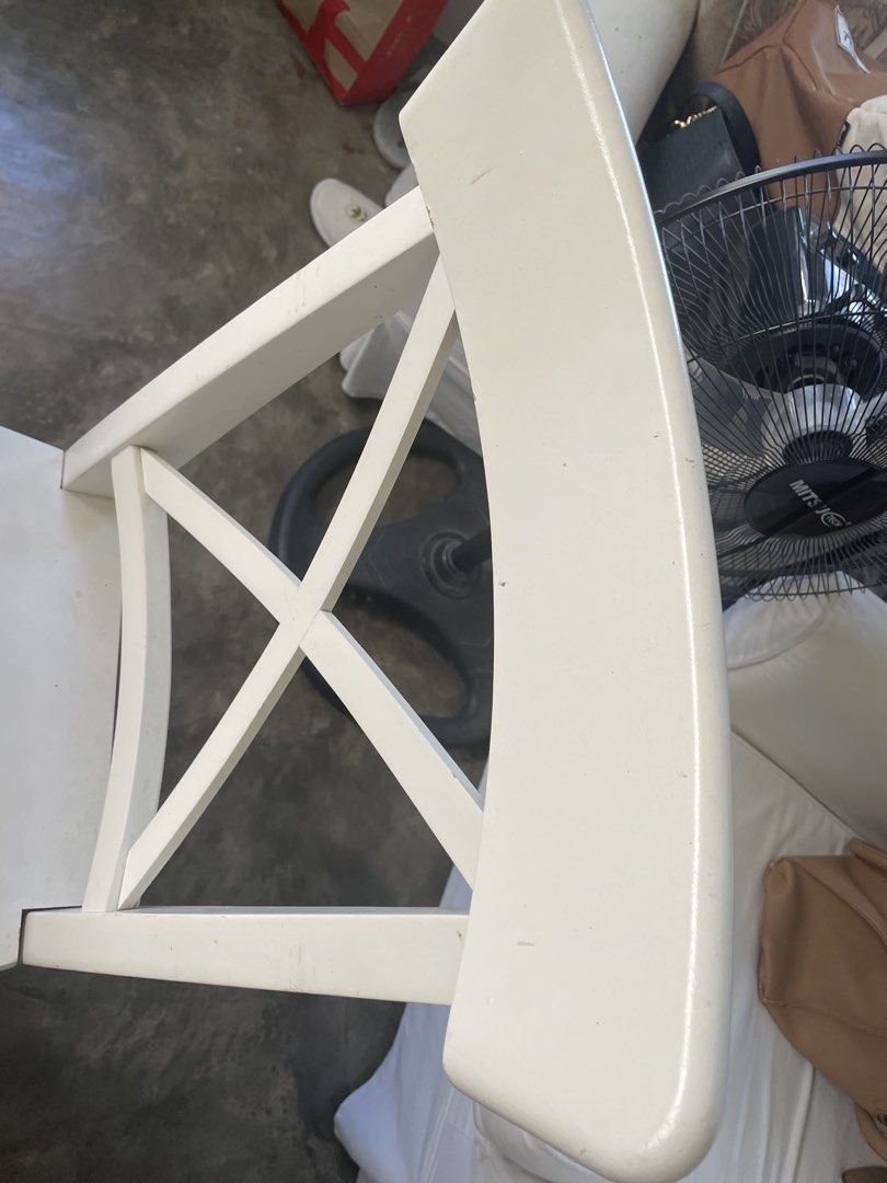 White Wooden Dining Chair (Category: Chairs) located in Santa Rosa. Submitted by emelyn71 (Listing ID 1436472492, Image 3). Description: - White wooden dining chair - Features an X-shaped back design - Square seat - Curved backrest - Minor marks present - Painted white.