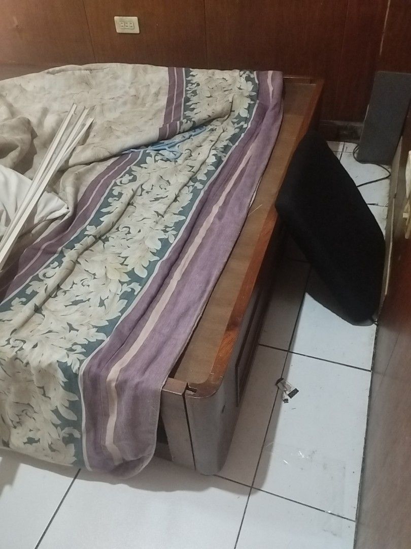 Wooden Bed Frame (Category: Bed Frames & Mattresses) located in Manila. Submitted by deguzmandh17516 (Listing ID 1436507125, Image 2). Description: - Wooden single bed frame - Brown finish - Rectangular shape - Includes headboard and footboard.