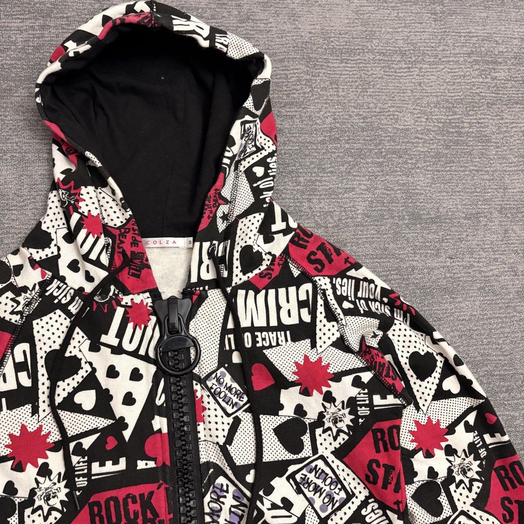 Y2K Emo Punk Rock Era All Over Print Jacket (Category: Coats, Jackets and Outerwear) located in Batangas. Submitted by bermudaph.2 (Listing ID 1436650242, Image 2). Description: Based on the image provided, this is a graphic print zip-up hoodie by the brand COLZA. It features an all-over "punk" or "rock" aesthetic with black, white, and pink motifs including hearts, stars, and bold text like "CRIMINAL" and "ROCK STAR." A notable design element is