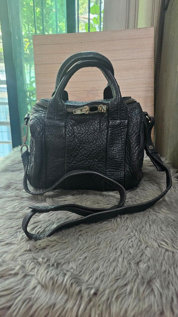 Alexander Wang Rocco Duffel Bag (Category: Luxury Bags & Wallets) located in Manila. Submitted by everythingnice8888 (Listing ID 1436655846, Image 1). Description: - Authentic Alexander Wang Rocco Duffel Bag - Black leather with textured finish - Top handle and detachable shoulder strap - Secure zip closure - Stylish silver-tone hardware - Iconic studded base .