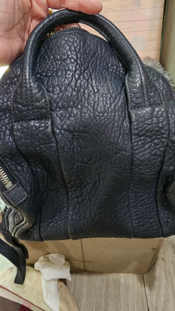 Alexander Wang Rocco Duffel Bag (Category: Luxury Bags & Wallets) located in Manila. Submitted by everythingnice8888 (Listing ID 1436655846, Image 2). Description: - Authentic Alexander Wang Rocco Duffel Bag - Black leather with textured finish - Top handle and detachable shoulder strap - Secure zip closure - Stylish silver-tone hardware - Iconic studded base .