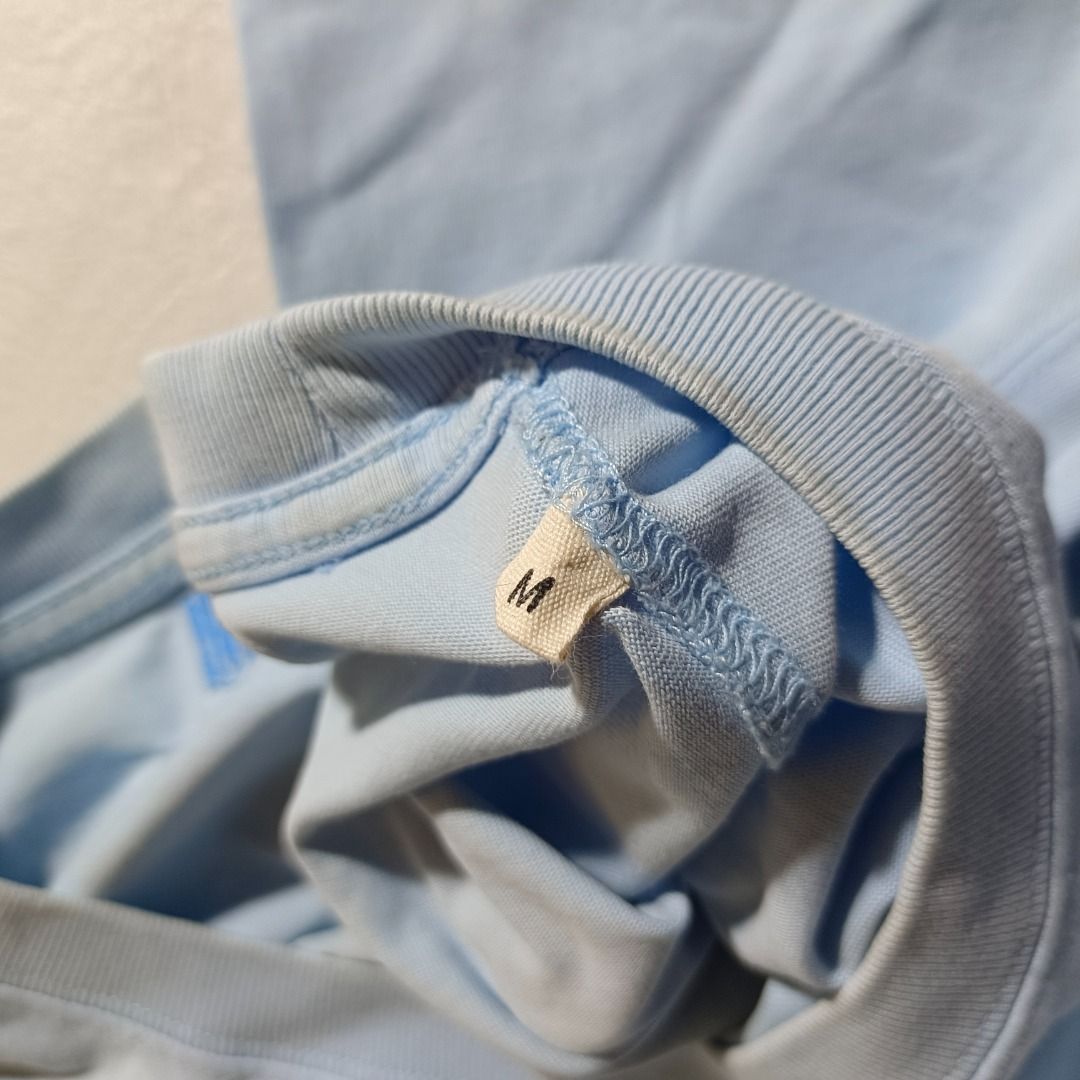 AMI LIGHT BLUE SHIRT (Category: Activewear) located in Baguio. Submitted by freshmarket_2600 (Listing ID 1436671736, Image 2). Description: Brand: Ami Tags: washtag and shoulder size tag only Size: M on tag Dimension: L28W21.5 Condition: Excellent Color rate: 10/10 Color: Blue Issue/s: None.