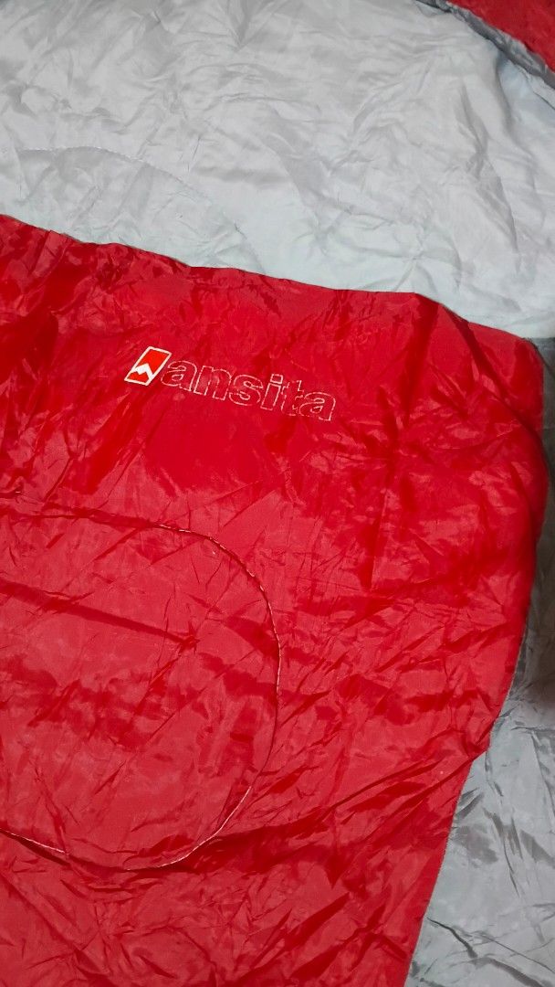 Ansita Sleeping Bag (Category: Hiking & Camping) located in San Ildefonso. Submitted by rigor32eva20161 (Listing ID 1436732690, Image 3). Description: - Red and gray sleeping bag - Features Ansite logo - Drawstring closure - Well-padded for comfort - Approximately 86 inches long - Ideal for camping and outdoor use.