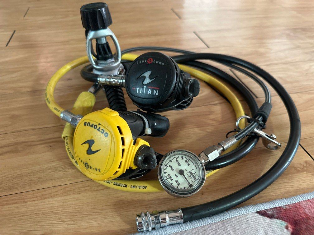 Aqualung Titan Scuba Regulator Set (Category: Other Sports Equipment and Supplies) located in Manila. Submitted by oceancitygirl (Listing ID 1436693602, Image 1). Description: - Aqualung Titan regulator set. - Includes: - Primary regulator (black) - Octopus regulator (yellow) - Pressure gauge (white face, black markings) - Hoses: Black and yellow - All components in good working order. RFS: Decluttering.