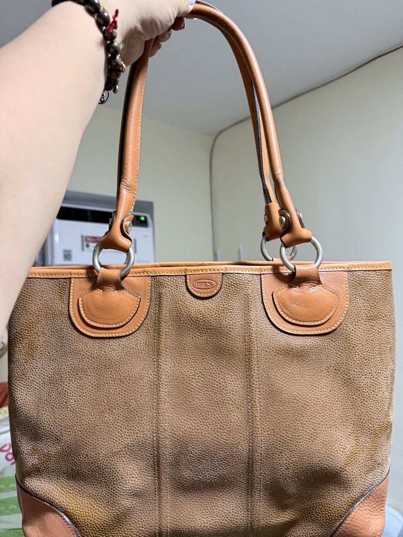 Authentic BRIC'S Tote Bag (Category: Tote Bags) located in Cavite. Submitted by lady_speculator_ph (Listing ID 1436821518, Image 1). Description: - Authentic BRIC'S tote bag in brown - Textured exterior - Genuine leather accents and handles - Fabric lined interior - Small interior pocket - Secure zipper closure - Brand logo visible - Hardware have fading, but still looks polished.
