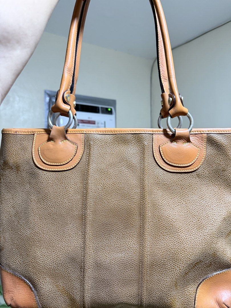 Authentic BRIC'S Tote Bag (Category: Tote Bags) located in Cavite. Submitted by lady_speculator_ph (Listing ID 1436821518, Image 2). Description: - Authentic BRIC'S tote bag in brown - Textured exterior - Genuine leather accents and handles - Fabric lined interior - Small interior pocket - Secure zipper closure - Brand logo visible - Hardware have fading, but still looks polished.