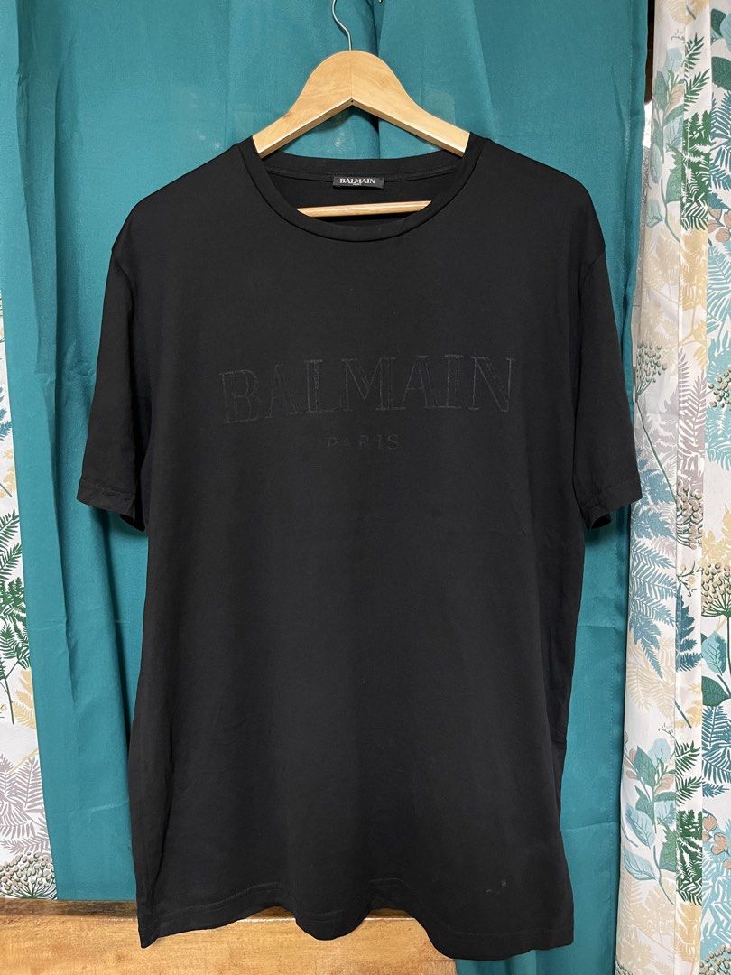 Balmain Paris Black T-shirt (Category: Tshirts & Polo Shirts ) located in General Santos City (Dadiangas). Submitted by crisjayg (Listing ID 1436672804, Image 1). Description: - Balmain Paris T-shirt - Black color - Features the Balmain logo - Made of 100% mercerized cotton - Length: Approximately 29 inches - Chest: Approximately 22 inches - Tag visible in photos.