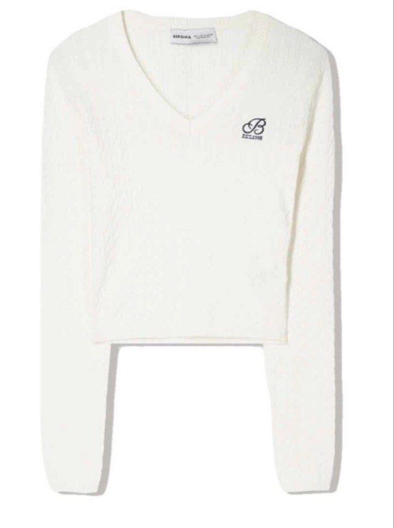 Bershka V-Neck Cropped Sweater (Category: Coats, Jackets and Outerwear) located in Manila. Submitted by trishaaysobel (Listing ID 1436673420, Image 1). Description: - V-neck design - Long sleeves - Cable knit texture - Small embroidered logo .