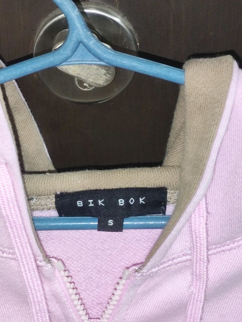 BIK BOK Pink Hoodie (Category: Coats, Jackets and Outerwear) located in Manila. Submitted by jerven_alonsabe (Listing ID 1436814187, Image 2). Description: - BIK BOK pink hoodie with brown sleeves - Size: Small - Features: - Front zipper - Hood - Crown design with "W" and "Ltd." on the front - Two front pockets.