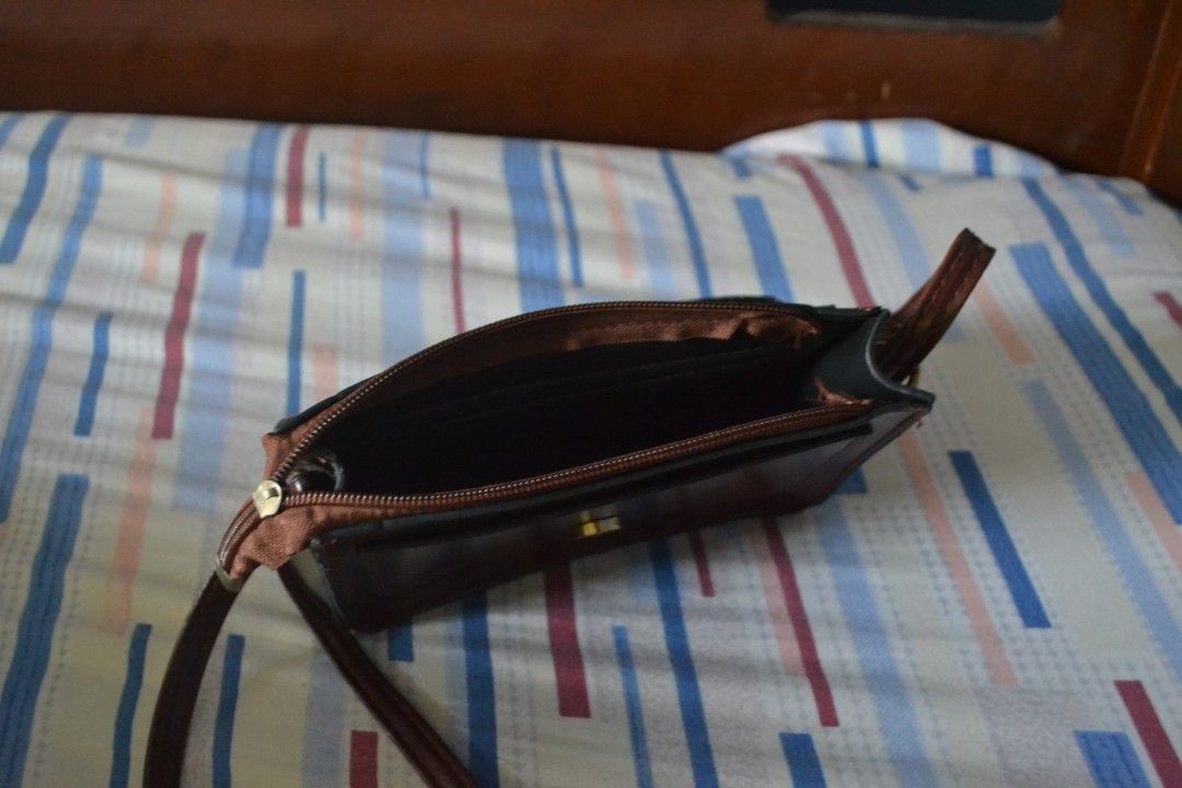 Brown Crossbody Bag (Category: Cross-body Bags) located in Valenzuela. Submitted by miss_merix (Listing ID 1436730799, Image 3). Description: - Brown crossbody bag - Flap closure with buckle - Long strap for shoulder or crossbody wear - Pure leather - From Saudi Arabia - Single main compartment with zipper - Rectangular shape - Darker interior lining.