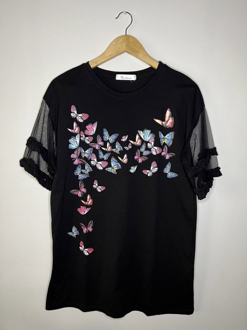 Butterfly Print Black T-shirt (Category: Shirts) located in Quezon City. Submitted by pcera (Listing ID 1436785257, Image 1). Description: - Black t-shirt - Butterfly print (front and back) - Mesh sleeves with ruffle details - Round neckline - 'Fashion' tag.