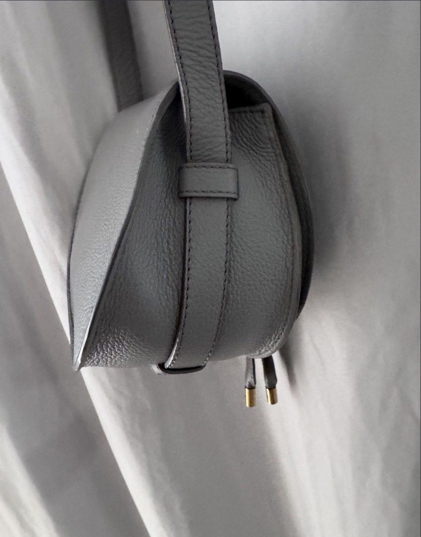 Chloe Mini Marcie Crossbody Bag (Category: Luxury Bags & Wallets) located in Manila. Submitted by decluterthings888 (Listing ID 1436813331, Image 3). Description: - Chloe Marcie Crossbody Bag - Saddle bag design with flap closure - Gray leather exterior - Adjustable long strap - Gold-tone hardware - Tassel detail - Main compartment and interior pocket - Suitable for everyday wear.
