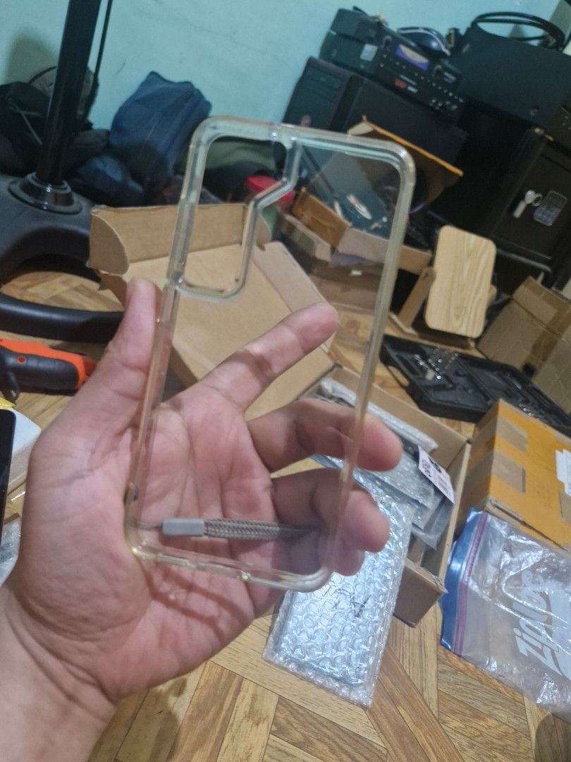 Clear Phone Case with Wrist Strap for s23 (Category: Cases & Sleeves) located in Quezon City. Submitted by kizuke (Listing ID 1436801678, Image 2). Description: - Clear phone case with wrist strap - Made of transparent plastic - Provides basic scratch and impact protection - Specifically designed for [Phone Model] - Features cutouts for camera and phone functions.