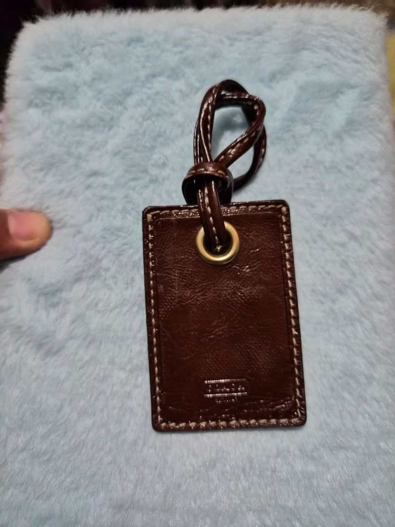 Coach Leather Luggage Tagp (Category: Other Audio Equipment) located in Mandaue City. Submitted by chuchi152615 (Listing ID 1436693956, Image 3). Description: - Genuine Coach luggage tag - Brown leather exterior - Stitched border - Gold-toned metal eyelet - Leather loop for attachment - Embossed Coach logo - Classic luggage accessory.