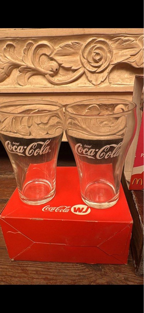 Coca-Cola Glasses Set (Category: Dinnerware & Cutlery) located in Mandaluyong City. Submitted by elainelawenko (Listing ID 1436709807, Image 2). Description: Set of Coca-Cola glasses. Includes various designs and styles, some with the classic Coca-Cola logo and others with unique shapes. Some glasses come with their original boxes. Perfect for collectors or anyone who enjoys a refreshing drink in a stylish glass..