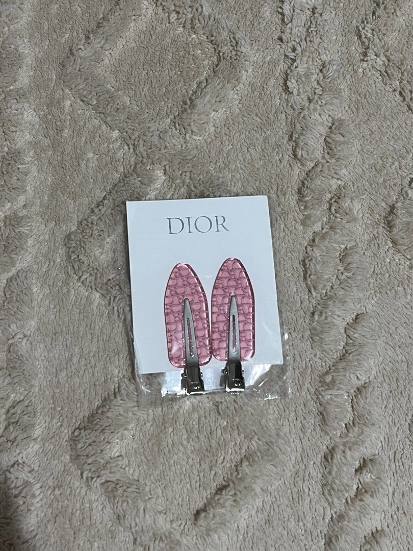 Dior Hair Clips (Category: Hair Accessories) located in Quezon City. Submitted by declutterwithrei (Listing ID 1436783573, Image 1). Description: Authentic Dior hair clips with a chic pink monogram pattern. Includes original packaging. Got this from my recent purchase..