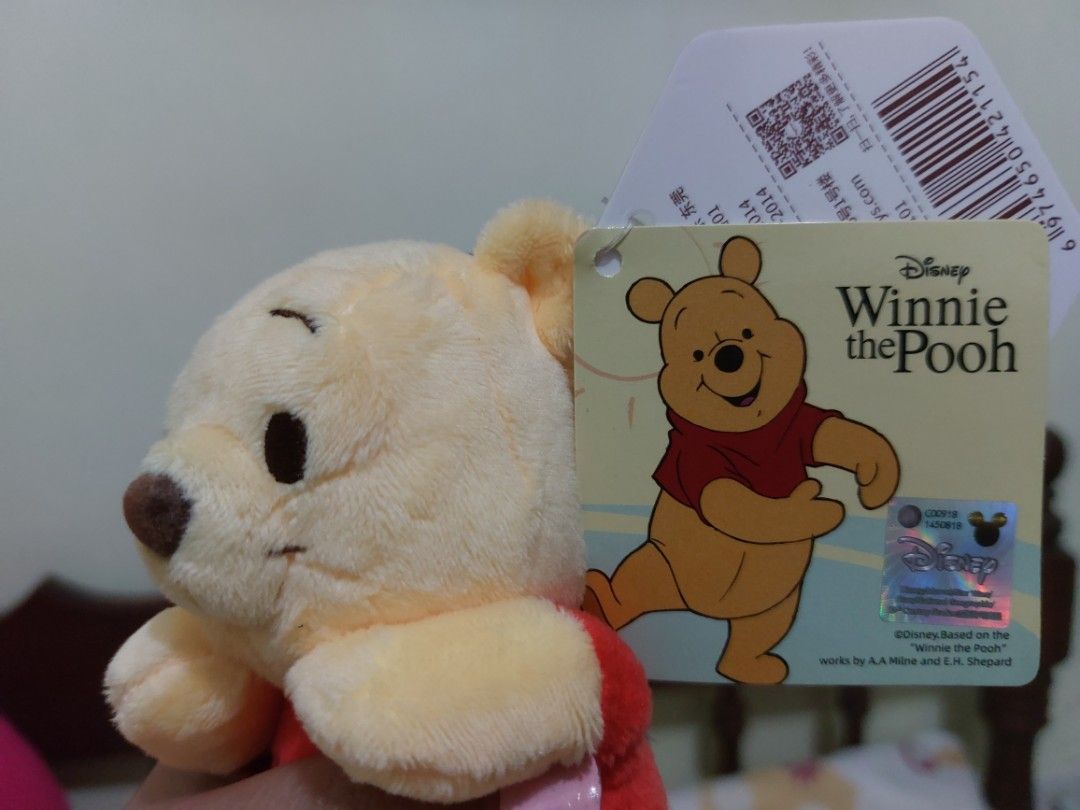 Disney Winnie the Pooh Plush Keychain (Category: Plushies & Soft Toys) located in Mandaluyong City. Submitted by 13thsilverrabbit (Listing ID 1436808302, Image 3). Description: Adorable Winnie the Pooh plush keychain. Features a classic design with Pooh wearing his iconic red shirt. Includes the original Disney tag. Perfect for fans of Winnie the Pooh or as a cute accessory for your bag or keys..