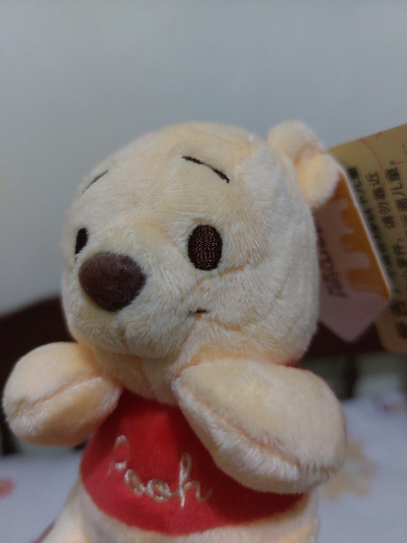 Disney Winnie the Pooh Plush Keychain (Category: Plushies & Soft Toys) located in Mandaluyong City. Submitted by 13thsilverrabbit (Listing ID 1436808302, Image 2). Description: Adorable Winnie the Pooh plush keychain. Features a classic design with Pooh wearing his iconic red shirt. Includes the original Disney tag. Perfect for fans of Winnie the Pooh or as a cute accessory for your bag or keys..