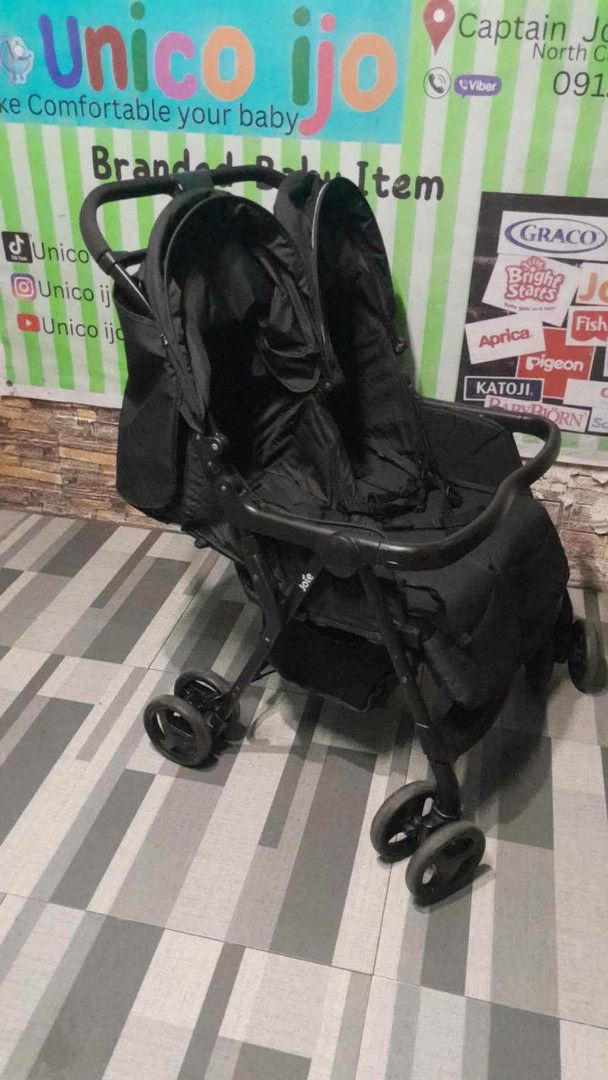Double Stroller - Black (Category: Strollers) located in Caloocan City. Submitted by Unicoijo02 (Listing ID 1436824724, Image 2). Description: - Black double stroller - Two seats with canopies - Convenient storage area - Four wheels for stability - Easy-to-maneuver handle - Designed for two children - Compact and suitable for daily use.