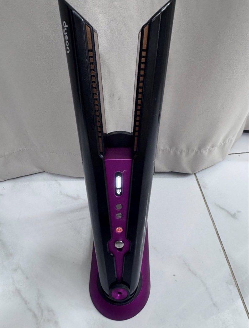 Dyson Corrale Hair Straightener (Category: Hair) located in Manila. Submitted by decluterthings888 (Listing ID 1436808982, Image 3). Description: - Dyson Corrale hair straightener - Color: Black, Silver, and Pink - Includes: Charging dock and travel pouch - Features flexing plates for enhanced styling - Multiple heat settings - Digital display - Designed to style with less heat.