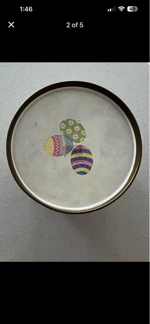Easter Drum Tin (Category: Vintage Collectibles) located in Petaling Jaya. Submitted by ena_hs (Listing ID 1436813613, Image 2). Description: Easter drum tin features adorable bunny illustrations around the sides and colorful Easter eggs on the lid. The bottom of the tin has a label indicating it once contained marshmallow and milk chocolate eggs. A charming collectible for Easter or a unique storage container. Location : Section 8, Kota Damansar