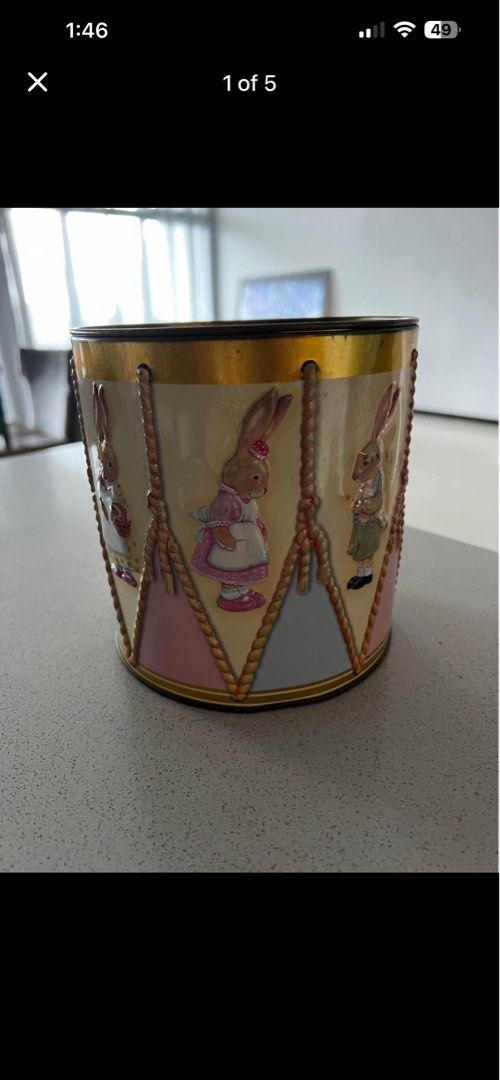 Easter Drum Tin (Category: Vintage Collectibles) located in Petaling Jaya. Submitted by ena_hs (Listing ID 1436813613, Image 1). Description: Easter drum tin features adorable bunny illustrations around the sides and colorful Easter eggs on the lid. The bottom of the tin has a label indicating it once contained marshmallow and milk chocolate eggs. A charming collectible for Easter or a unique storage container. Location : Section 8, Kota Damansar