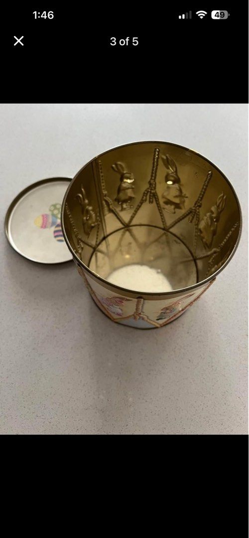 Easter Drum Tin (Category: Vintage Collectibles) located in Petaling Jaya. Submitted by ena_hs (Listing ID 1436813613, Image 3). Description: Easter drum tin features adorable bunny illustrations around the sides and colorful Easter eggs on the lid. The bottom of the tin has a label indicating it once contained marshmallow and milk chocolate eggs. A charming collectible for Easter or a unique storage container. Location : Section 8, Kota Damansar