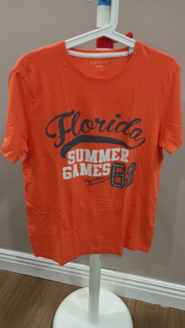 Esprit Florida Summer Games T-shirt (Category: Tshirts & Polo Shirts ) located in Quezon City. Submitted by ddgapstore (Listing ID 1436713906, Image 2). Description: - Orange Esprit t-shirt - Features "Florida Summer Games" graphic - Crew neck - Short sleeves - Lightweight material - Tag visible.