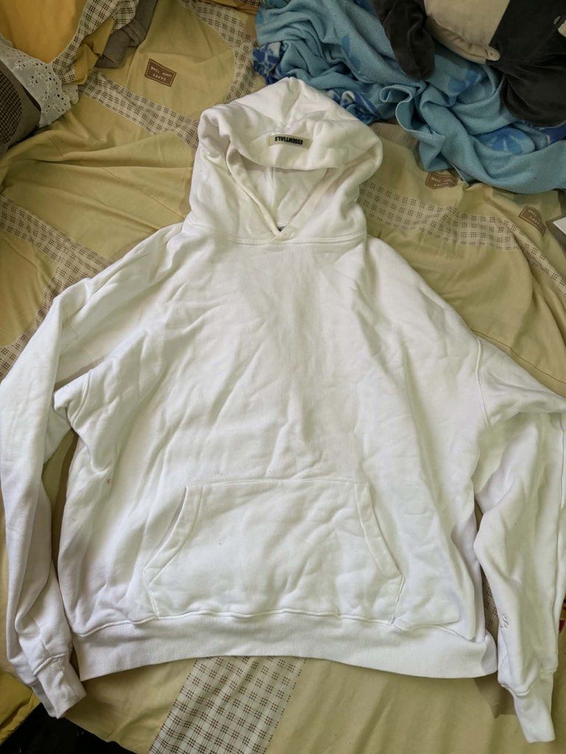 Essentials Fear of God Hoodie (Category: Hoodies) located in Manila. Submitted by scarlett.love (Listing ID 1436674861, Image 1). Description: - White Essentials Fear of God hoodie - Features a hood with the Essentials tag - Black Essentials logo printed on the back - Kangaroo pocket in the front - Relaxed fit - ORIGINAL.